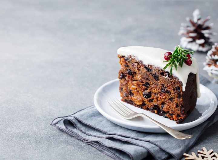 Christmas fruit cake, pudding on white plate. Copy space