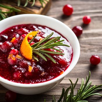 Cranberry sauce or cranberry jam with orange and rosemary. Close up.
